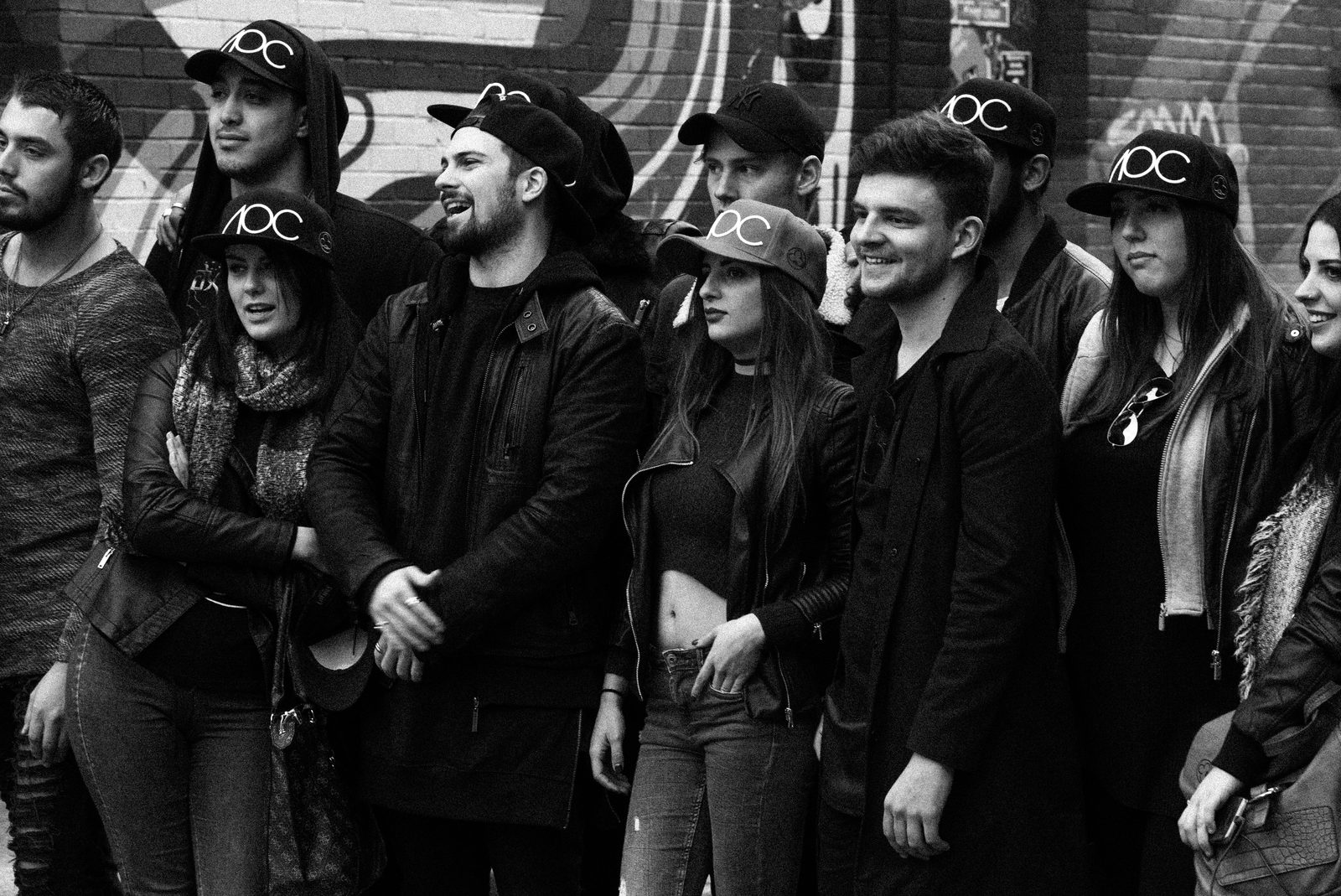Large AOC crew group posed together on a Shoreditch backstreet
