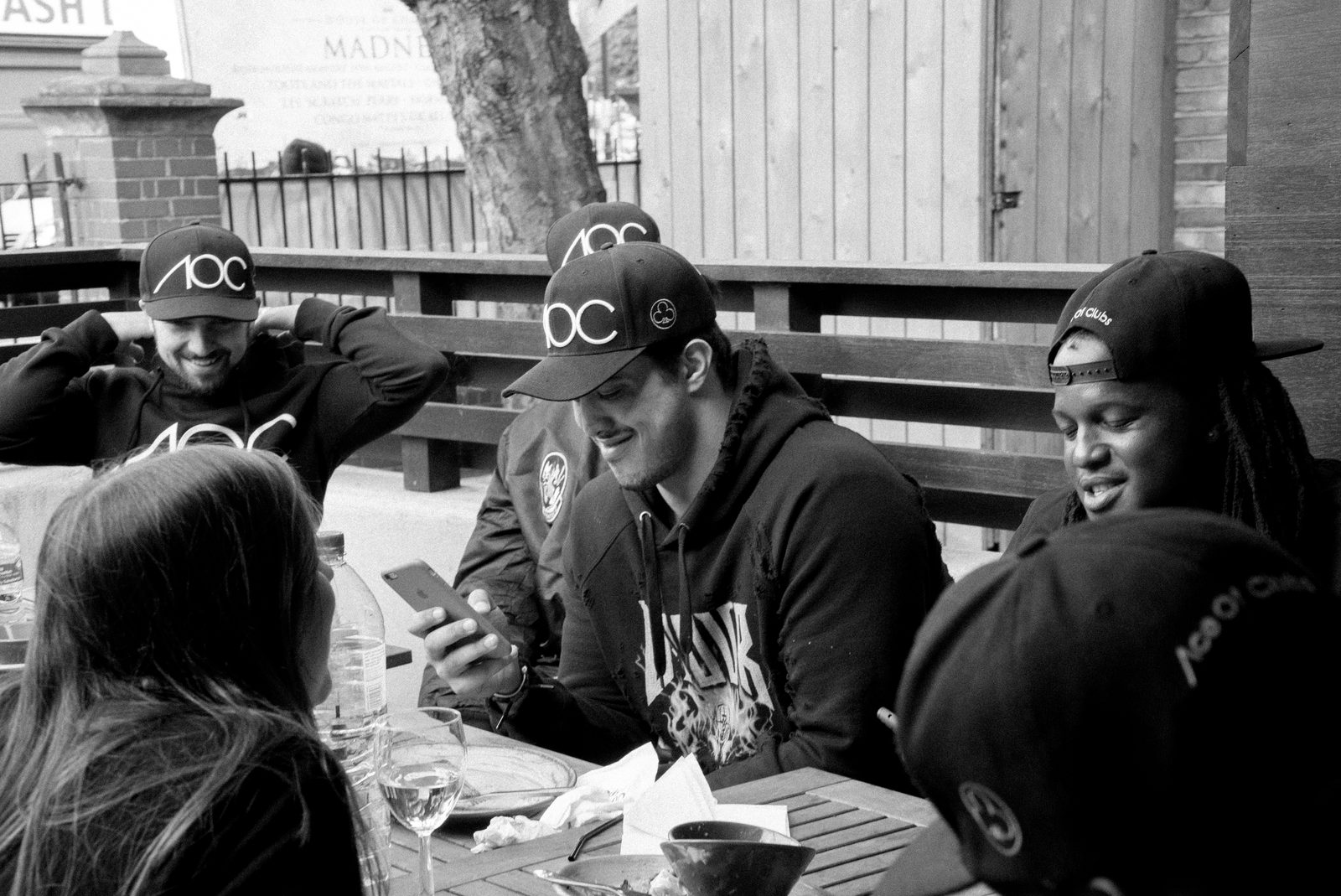AOC crew sitting around an outdoor table together, laughing and relaxed