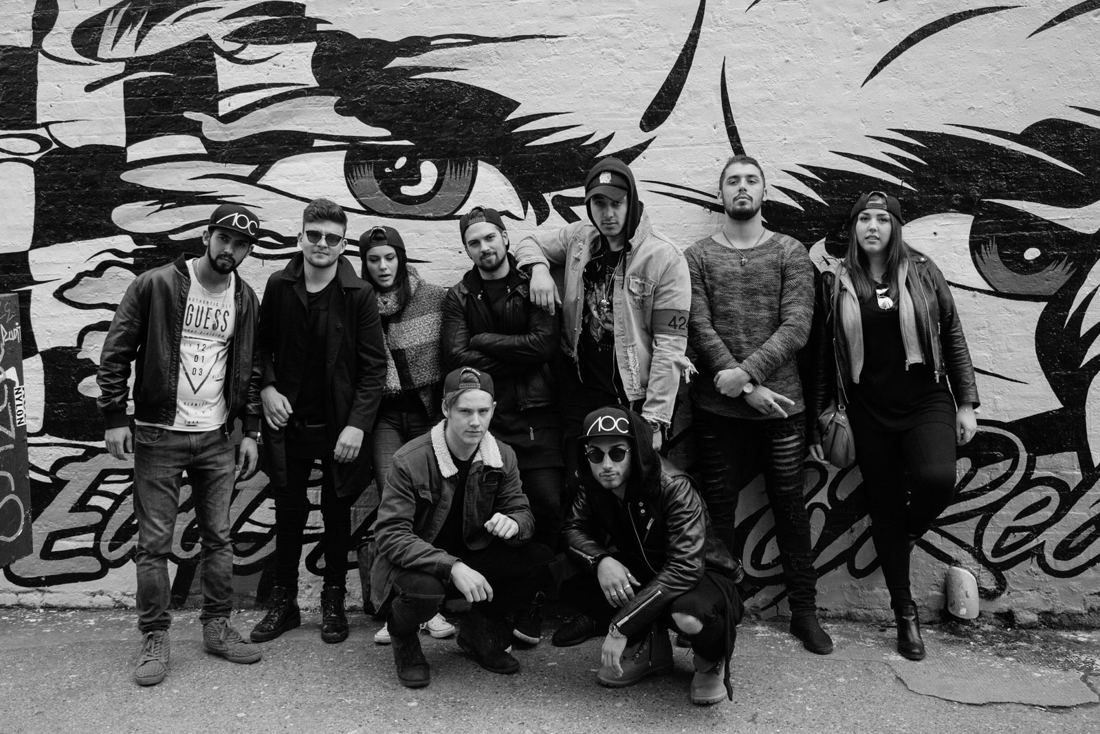 Full AOC crew group photo in front of a colourful Shoreditch street art mural